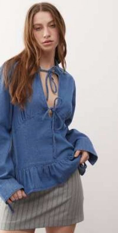 Reclaimed Vintage Reclaimed Vintage long sleeve denim tie front top with peplum hem in mid blue