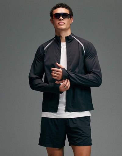 4505 4505 Premium woven water repellent running jacket with zip pockets and reflective detailing in void black