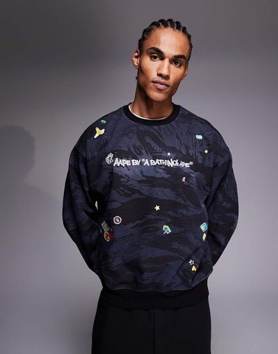 AAPE BY A BATHING APE® Aape By A Bathing Ape pullover sweatshirt in black camo with sweet stickers-Multi