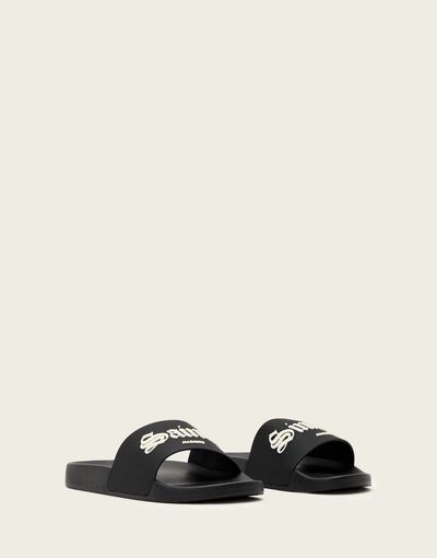AllSaints AllSaints Saints & Sinners logo slides in black