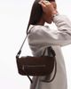 AllSaints Allsaints Vega suede mini shoulder bag in brown - 1