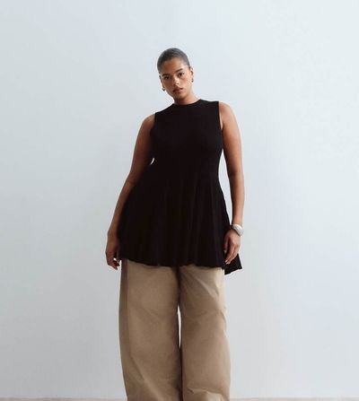 ARRANGE ARRANGE Curve knit sleeveless peplum top in black