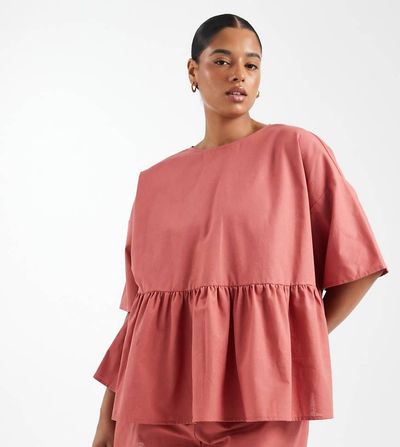 ASOS Curve ASOS DESIGN Curve oversized short sleeve peplum top in blush-pink