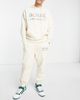 ASOS DESIGN ASOS Actual relaxed brushed cotton sweatpants with multi color logo print in cream - part of a set-White - 2