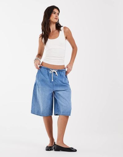 ASOS DESIGN ASOS DESIGN denim loose bermuda shorts with tie waist detail in mid blue
