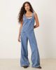 ASOS DESIGN ASOS DESIGN denim overalls jumpsuit with cross back in mid wash-Blue - 1