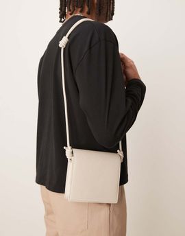 ASOS DESIGN ASOS DESIGN faux leather cross body bag with strap detail in ecru-Neutral