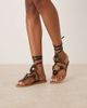 ASOS DESIGN ASOS DESIGN Fiona tortoise trim tie leg flat sandals in black - 1