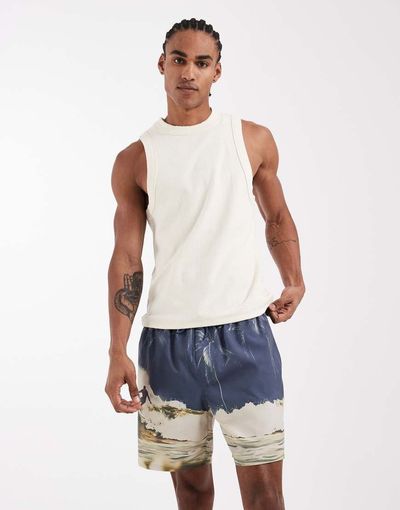 ASOS DESIGN ASOS DESIGN mid length swim shorts with blue beach photo print