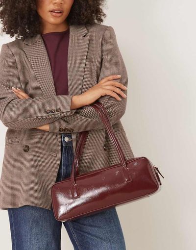 ASOS DESIGN ASOS DESIGN patent elongated shoulder bag in burgundy-Brown