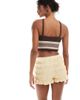 ASOS DESIGN ASOS DESIGN shirred texture micro shorts in buttermilk-Yellow - 4