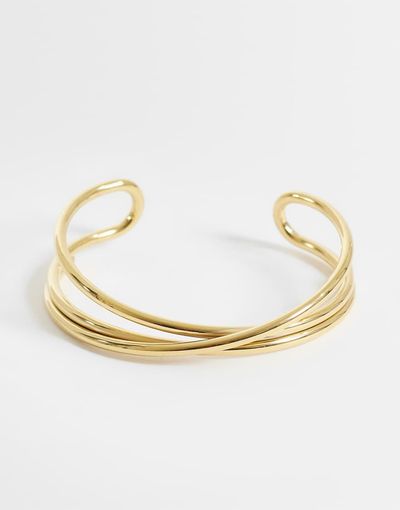 ASOS DESIGN ASOS DESIGN waterproof stainless steel cuff bracelet with cross-over design in gold tone