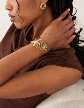 ASOS DESIGN ASOS DESIGN waterproof stainless steel cuff with starfish design in gold tone