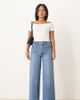ASOS Petite ASOS DESIGN Petite high rise wide leg jeans with front pockets in mid blue - 1