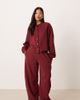 ASOS Petite ASOS DESIGN Petite interlock barrel leg sweatpants in burgundy-Red - 1