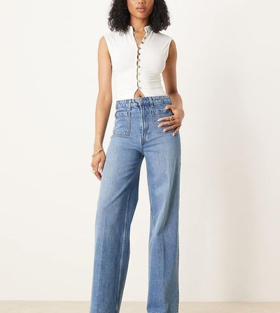 ASOS Tall ASOS DESIGN Tall high rise wide leg jeans with front pockets in mid blue