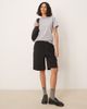 AWARE AWARE pleat front tailored shorts in black - 1
