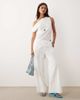 BRONZE SNAKE BRONZE SNAKE Tasi off the shoulder asymmetric top and pants set in white - 1