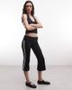 Collusion COLLUSION flared capri leggings in black with sporty stripe - 1