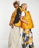 Collusion COLLUSION Unisex high shine collarless oversized padded vest in mustard-Yellow - 1