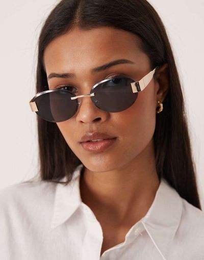 GINA TRICOT Gina Tricot rimless sunglasses in black and gold tone