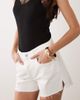 Good American Good American vintage mid rise longline denim shorts in white - 3