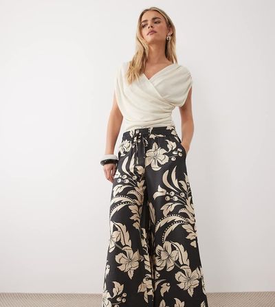 JDY Petite JDY Petite wide leg pants in black with cream floral print