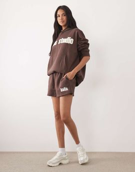 Kaiia Kaiia Studio cotton rich embroidered logo sweat shorts in brown & yellow - part of a set