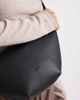 PASQ PASQ textured croissant crossbody bag in black - 2