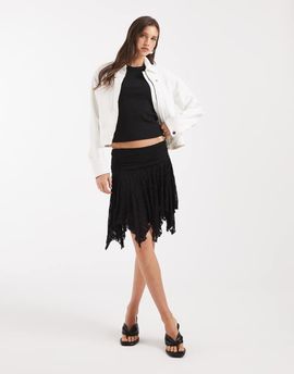 Pieces Pieces asymmetric hem flippy lace mini skirt in white-Black