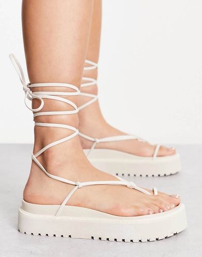 Public Desire Public Desire Elevate heeled sandals with bow in clear and beige-Neutral