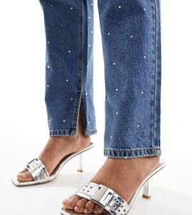 Simmi Wide Fit Simmi London Wide Fit Bexley mid heeled mules with grommet buckle detail in silver