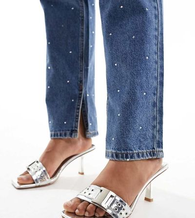 Simmi Wide Fit Simmi London Wide Fit Bexley mid heeled mules with grommet buckle detail in silver