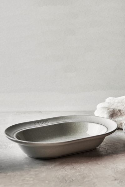 Staub Staub Ceramic Dinnerware 10-inch Oval Stoneware Serving Dish in White Truffle at Urban Outfitters
