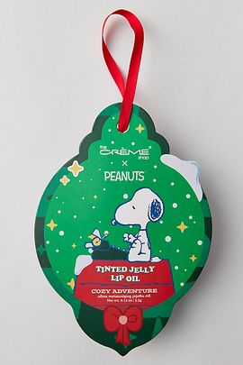 The Crème Shop The Crème Shop X Peanuts Tinted Jelly Lip Oil Ornament in Champagne Shimmer at Urban Outfitters