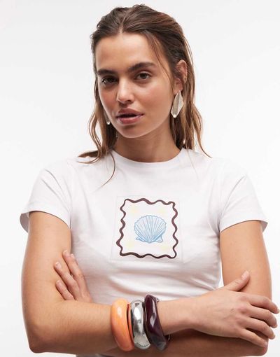 The Frolic The Frolic exclusive shell graphic front baby tee in white