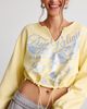 TRUE RELIGION True Religion Glitter Graphic Notch V-Neck Pullover Top in Double Cream, Women's at Urban Outfitters - 1
