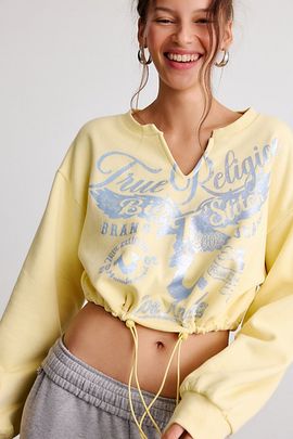 TRUE RELIGION True Religion Glitter Graphic Notch V-Neck Pullover Top in Double Cream, Women's at Urban Outfitters