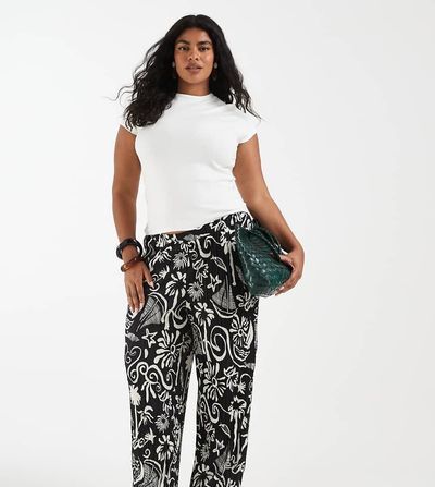 Vero Moda Curve Vero Moda Curve high waist wide leg plisse pants in tropical conversational print-Black