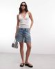 Weekday Weekday low waist baggy denim shorts with twisted front seam in blue wash - 1